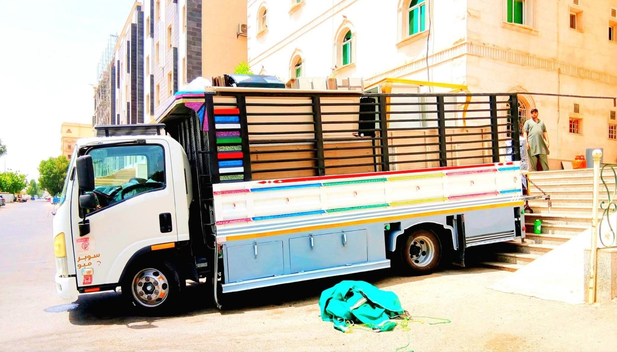 Movers carrying boxes during an office shifting project in Jeddah